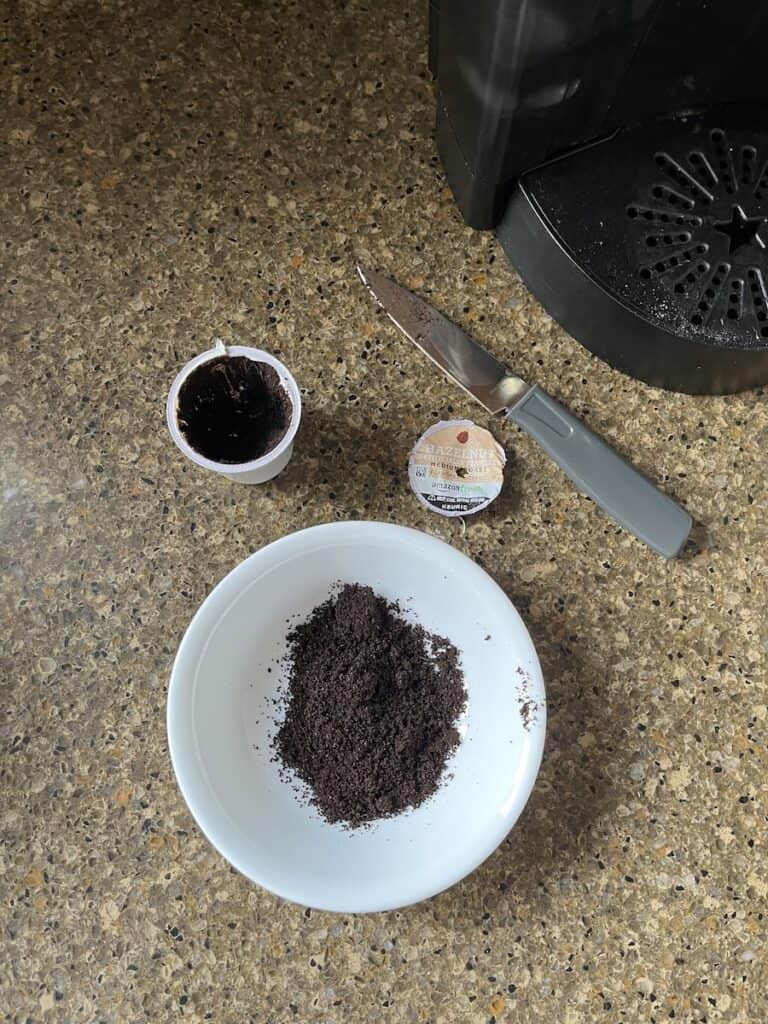 top removed from k cup and grounds in bowl