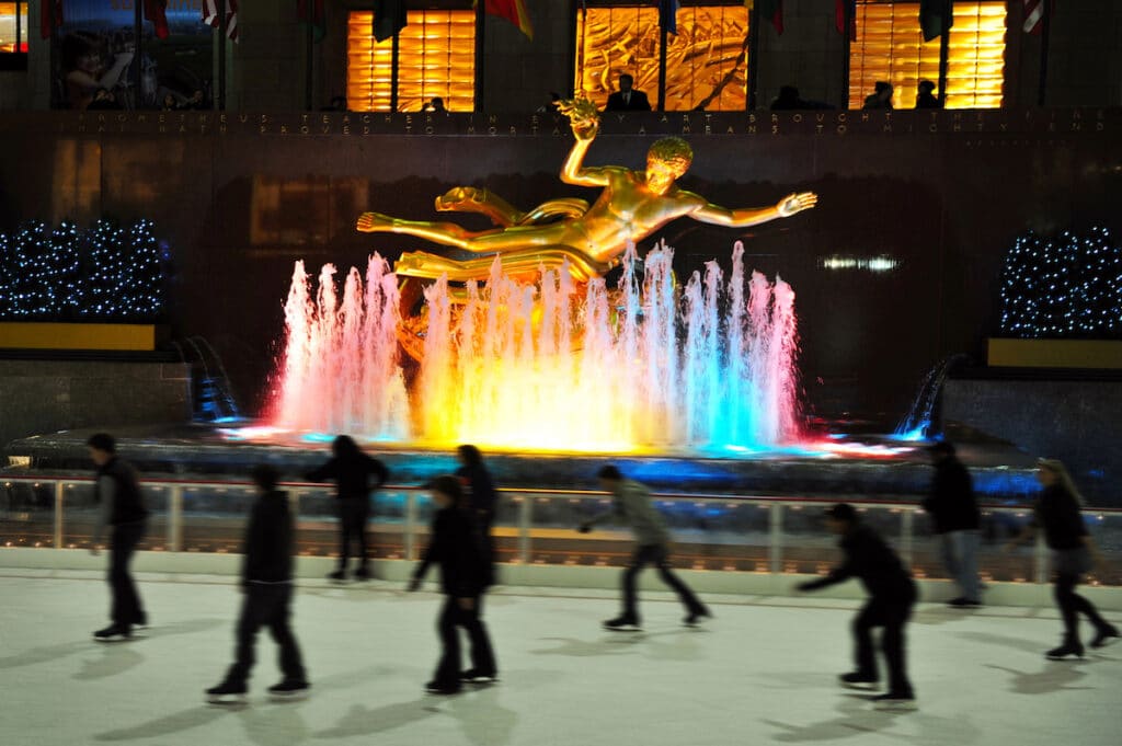 People ice skate at the famous ice arena of Rockefeller Center during winter time in Manhattan New York, USA.