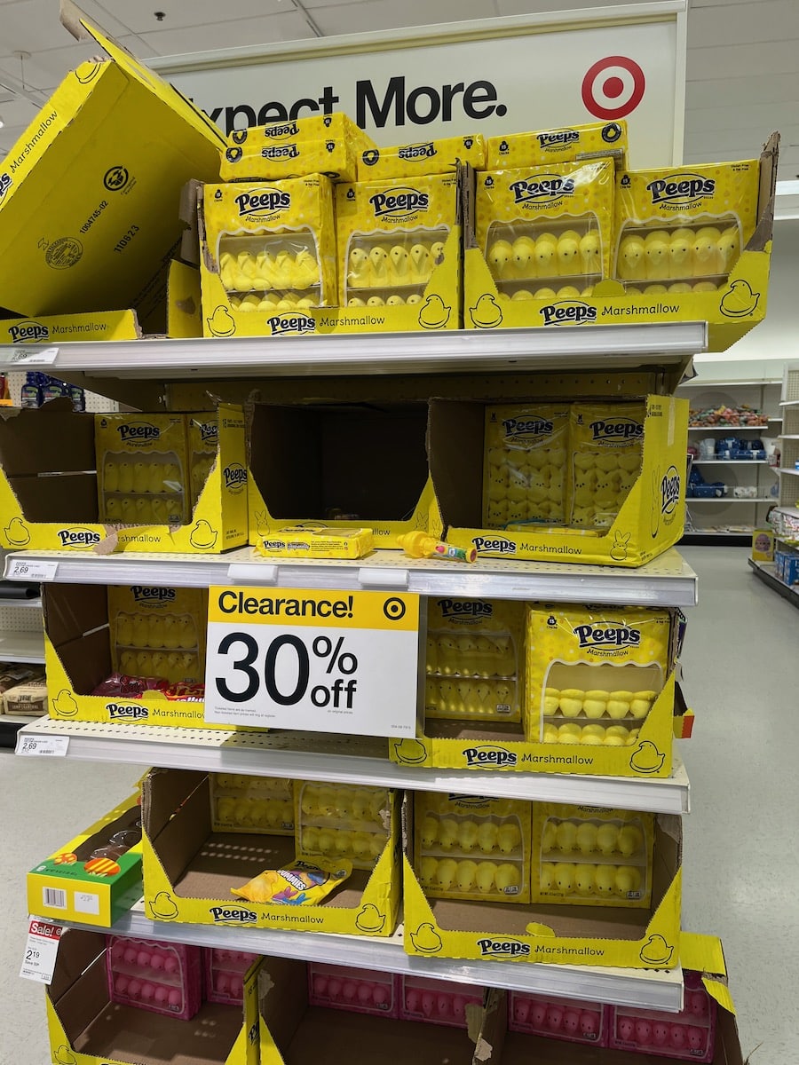 Yellow peeps marshmallow candies on store shelves with a 30% off clearance sign for after Easter sales.